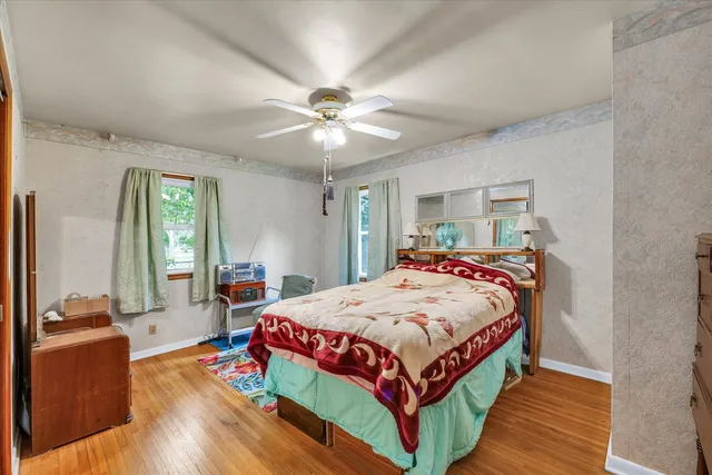 a bedroom with a bed and a chandelier