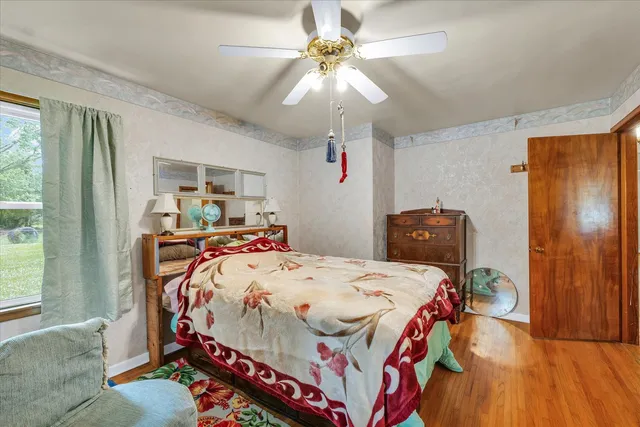 a bedroom with a bed and a chandelier