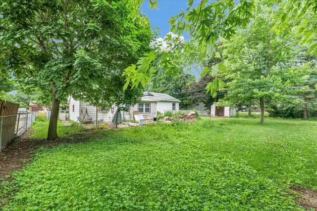 a view of a house with backyard and a sitting area