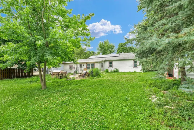 a view of a house with backyard and garden