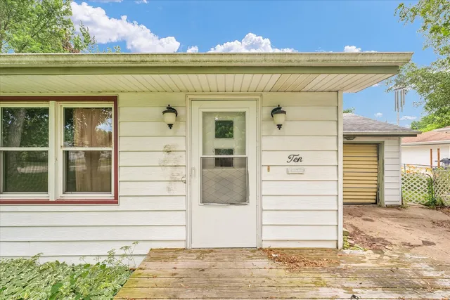 a view of front door and potted plants