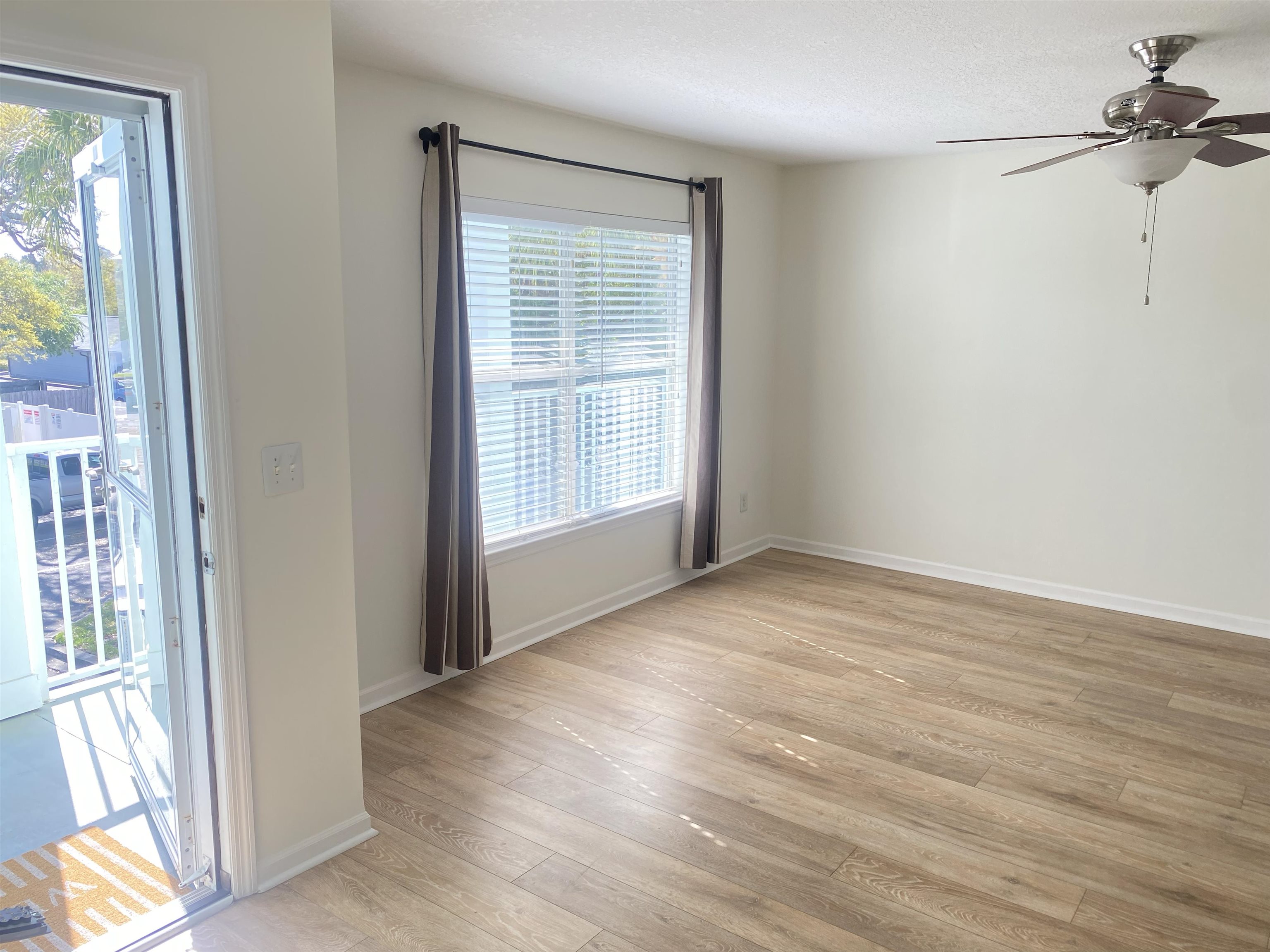 204 16th Street, Unit G St. Augustine Beach, FL 32080 - Photo 11 of 31 an empty room with wooden floor and windows