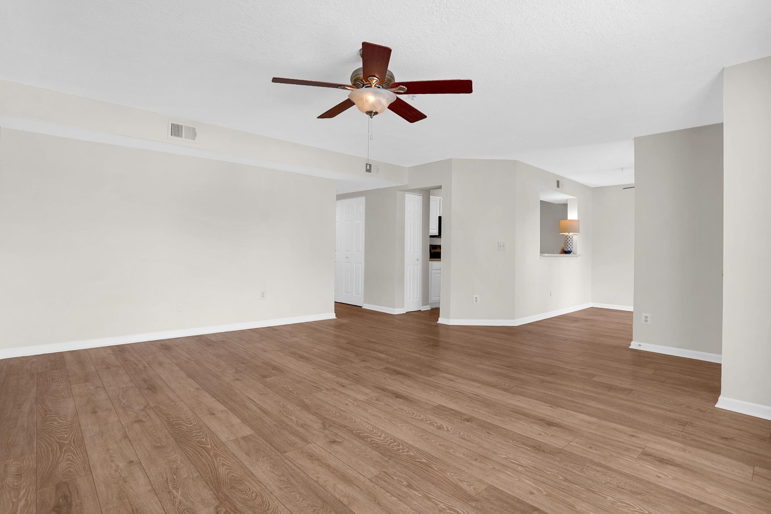 204 16th Street, Unit G St. Augustine Beach, FL 32080 - Photo 14 of 31 a view of empty room with wooden floor and ceiling fan