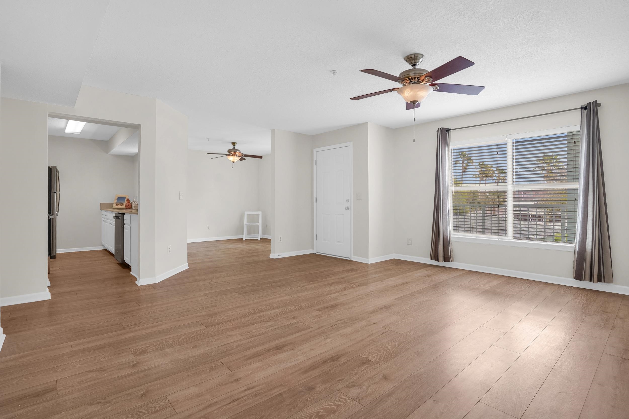 204 16th Street, Unit G St. Augustine Beach, FL 32080 - Photo 15 of 31 a view of empty room with wooden floor and fan
