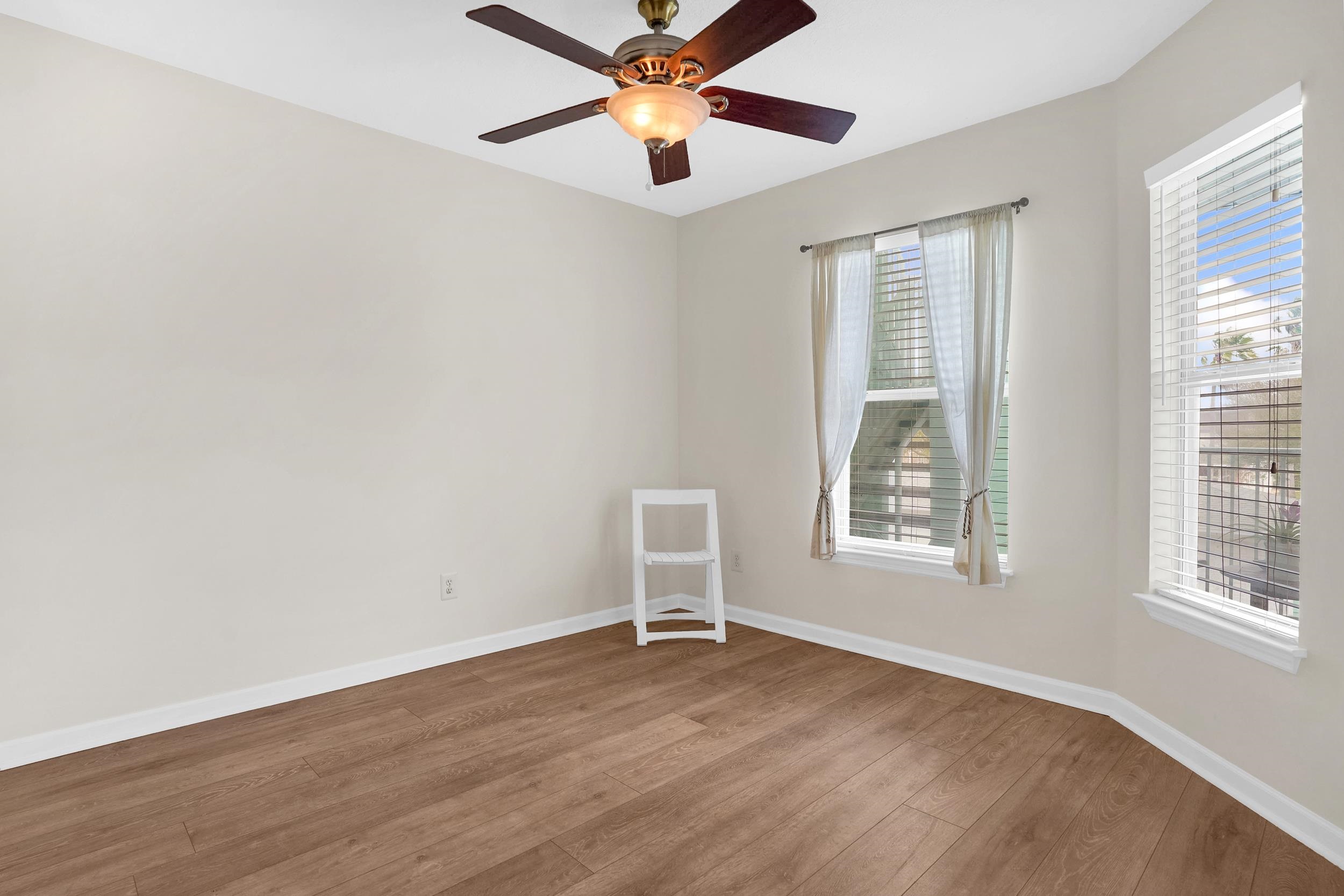 204 16th Street, Unit G St. Augustine Beach, FL 32080 - Photo 16 of 31 an empty room with windows and fan