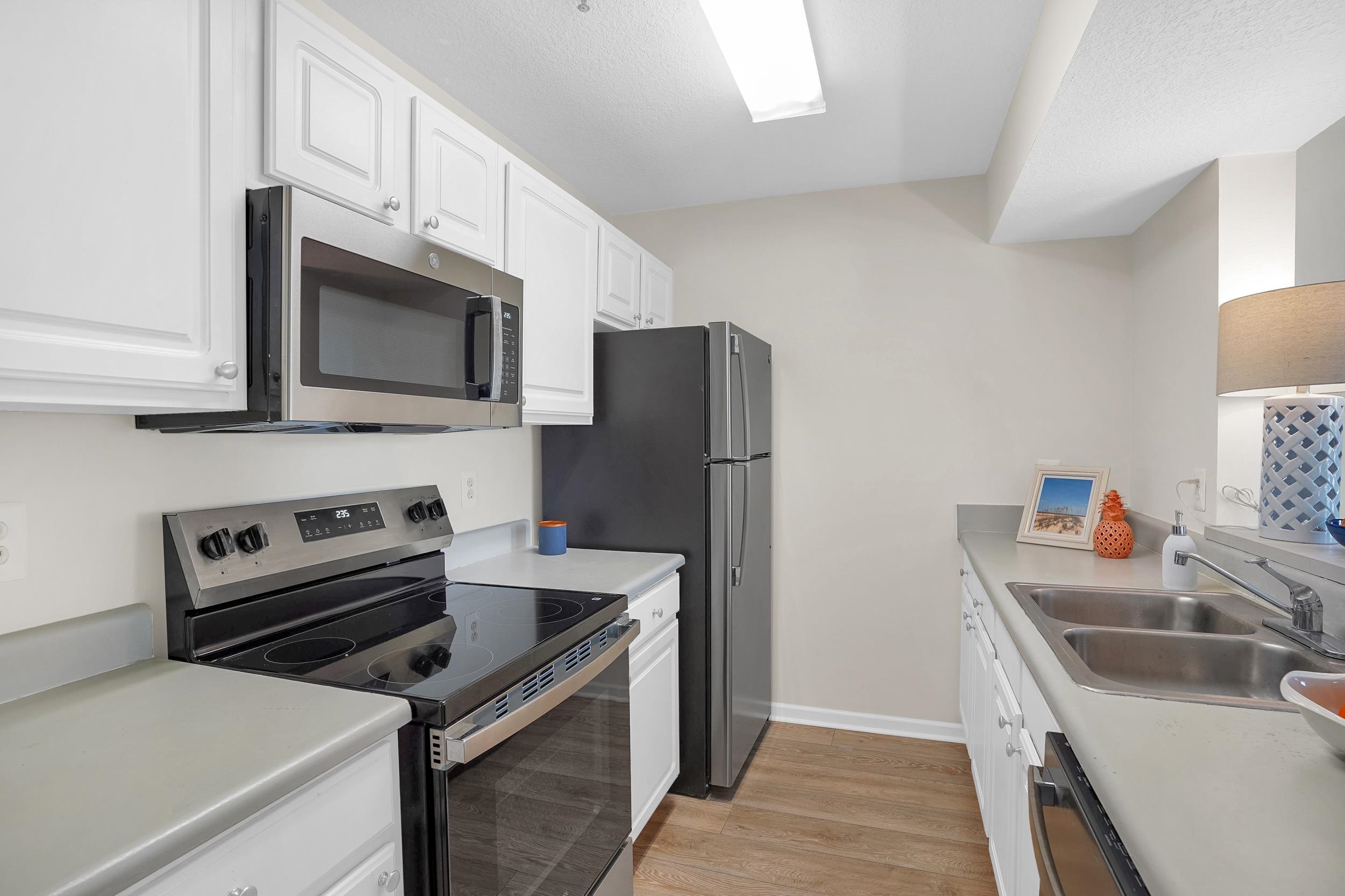 204 16th Street, Unit G St. Augustine Beach, FL 32080 - Photo 19 of 31 a kitchen with a refrigerator stove and microwave