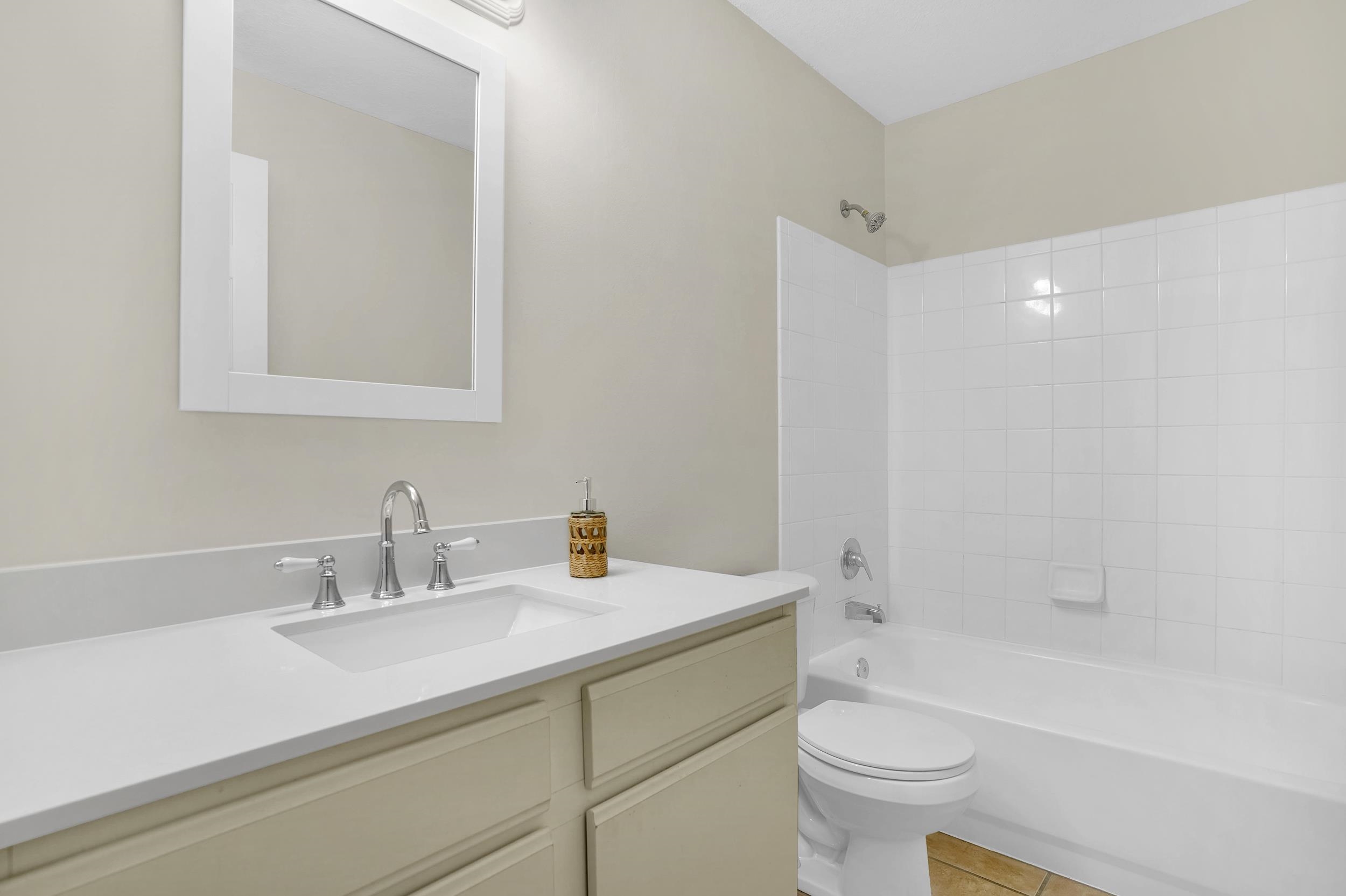 204 16th Street, Unit G St. Augustine Beach, FL 32080 - Photo 21 of 31 a bathroom with a sink a toilet and a bathtub