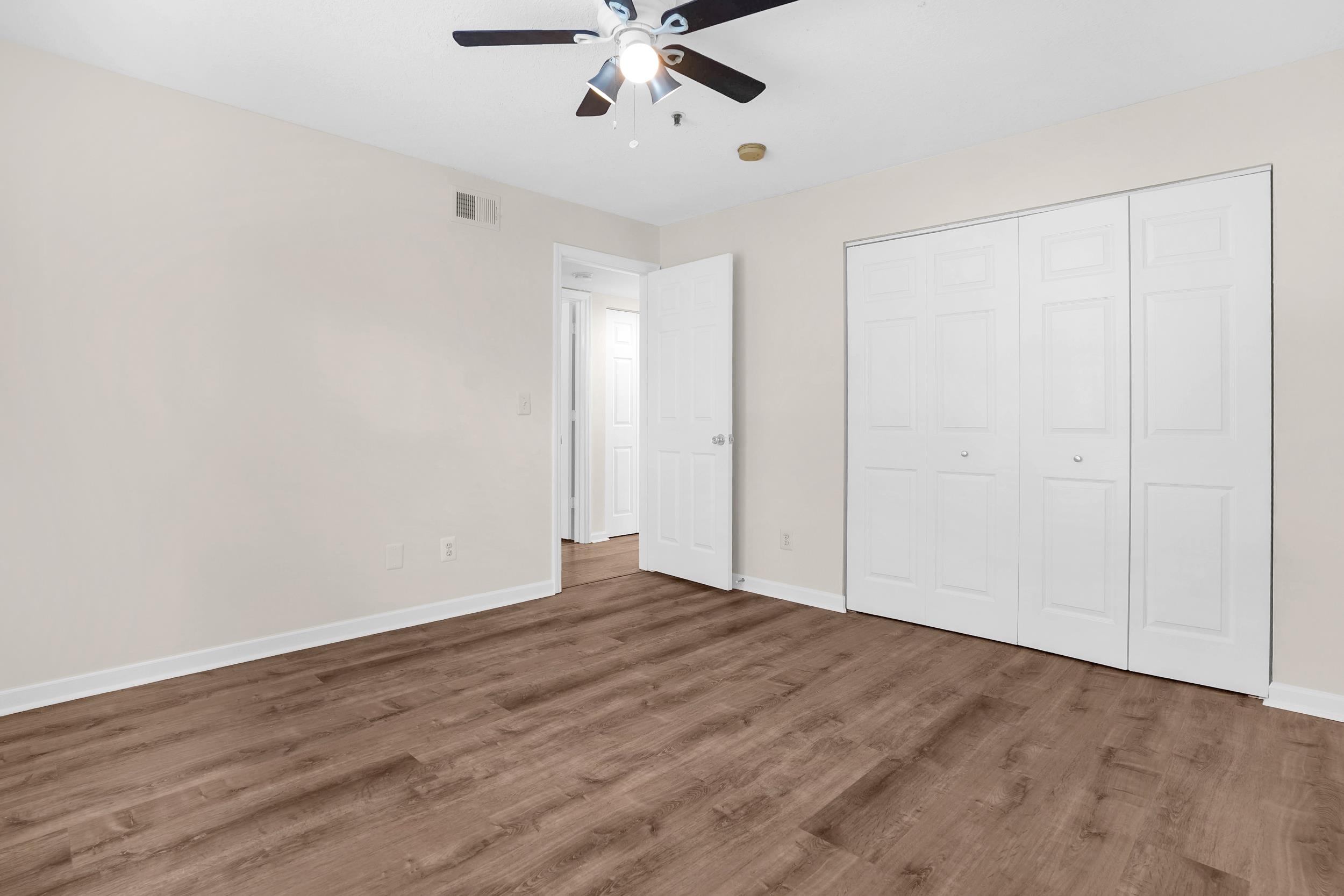 204 16th Street, Unit G St. Augustine Beach, FL 32080 - Photo 24 of 31 a view of an empty room with wooden floor