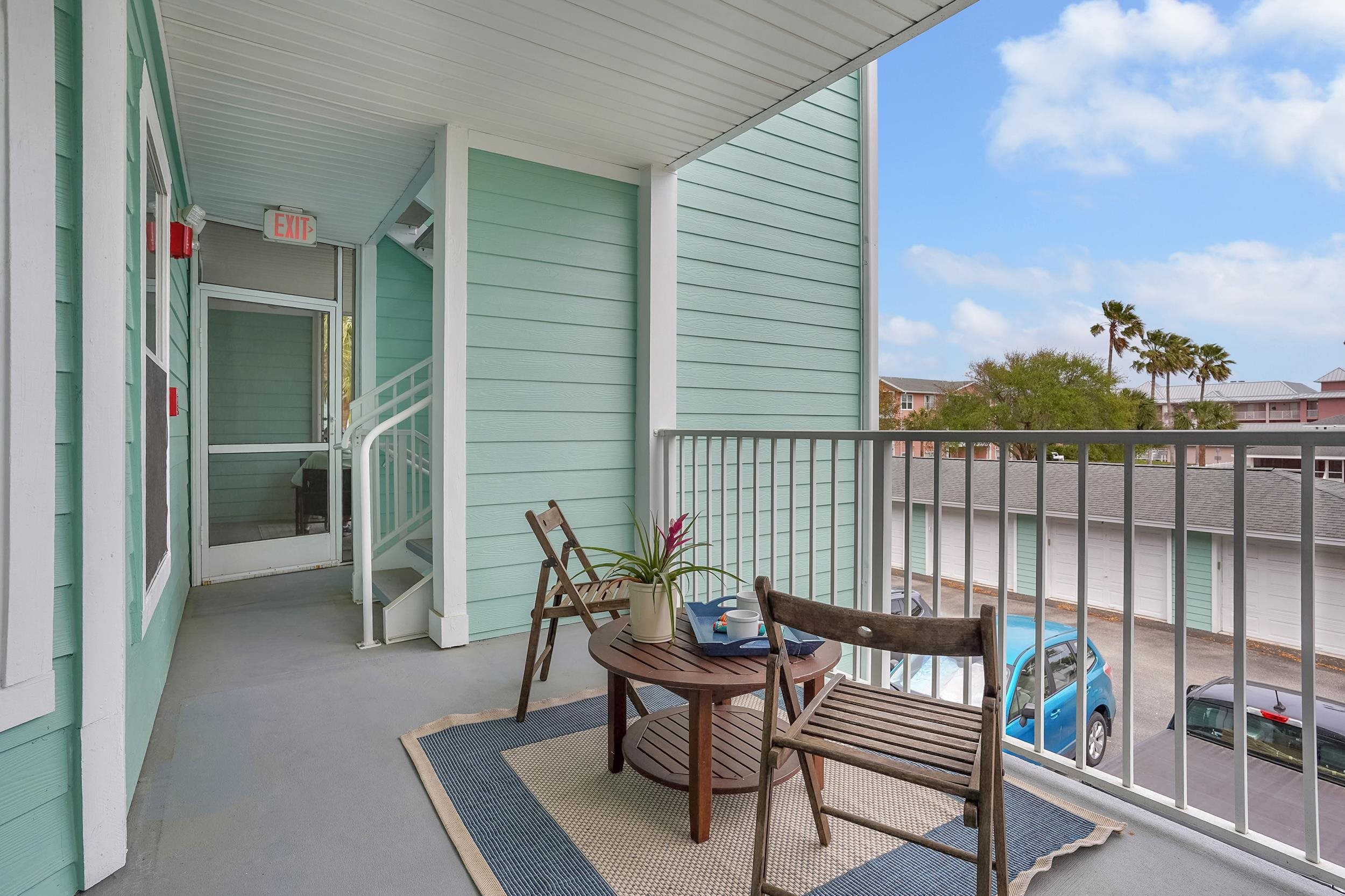 204 16th Street, Unit G St. Augustine Beach, FL 32080 - Photo 4 of 31 a porch with a bench next to a yard