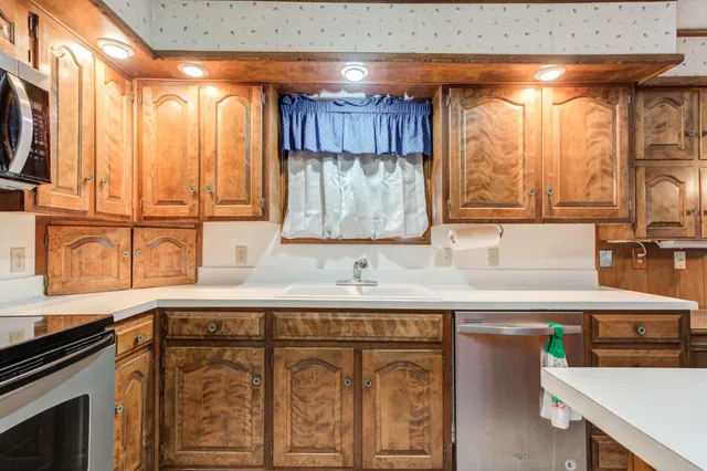 a kitchen with a stove a sink and a refrigerator