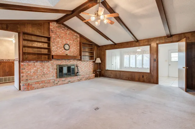 a view of empty room with cabinet and fireplace