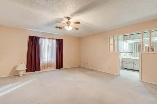 a view of an empty room with a cabinet