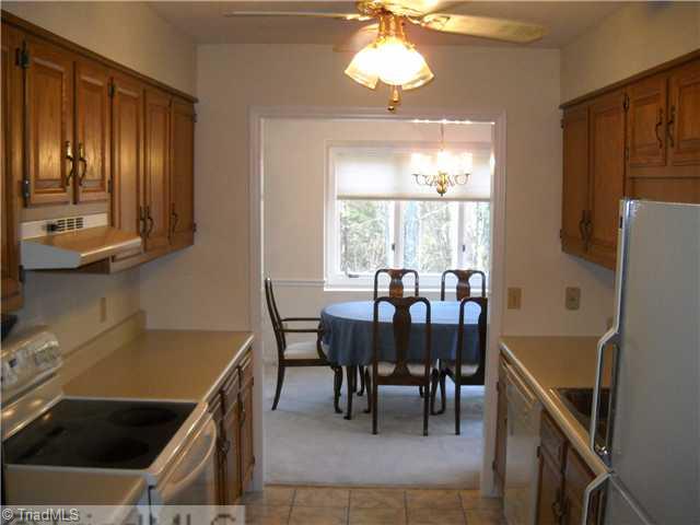 142 Old Mill Road, Unit D High Point, NC 27265 - Photo 2 of 16 Kitchen. Galley kitchen with smooth top range, refrigerator, dishwasher and oak cabinets.