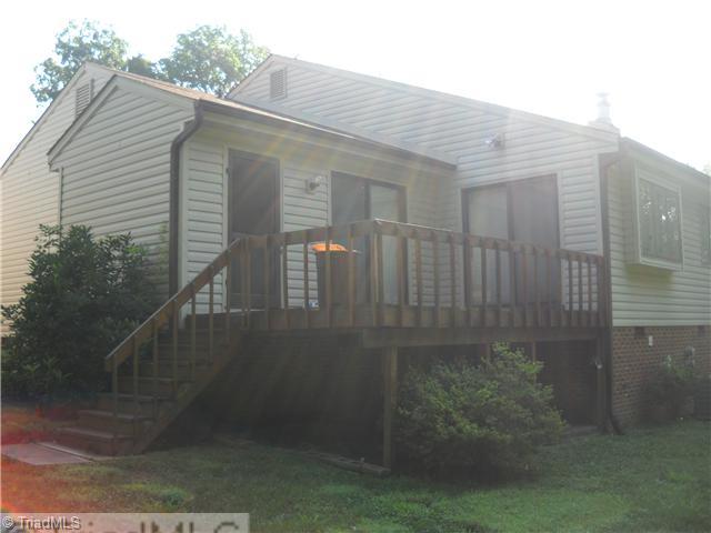 142 Old Mill Road, Unit D High Point, NC 27265 - Photo 11 of 16 Exterior Back. Door on the left is a storage room. Deck overlooks lawn and wooded area.