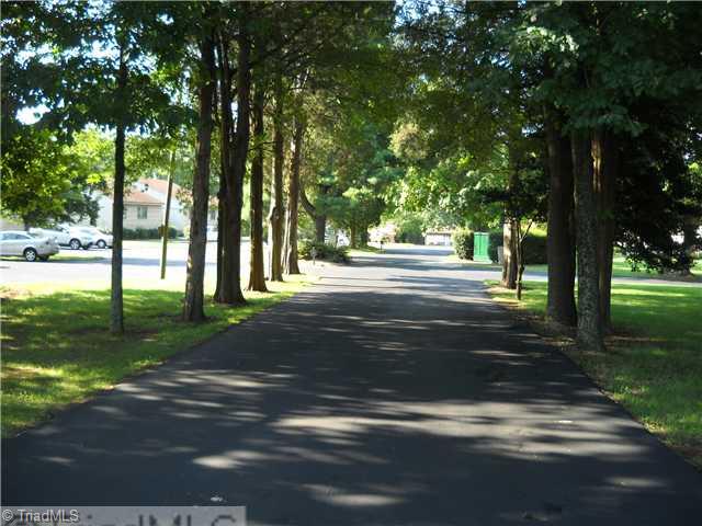 142 Old Mill Road, Unit D High Point, NC 27265 - Photo 14 of 16 Entry. Tree-lined driveway leads into the townhome community.