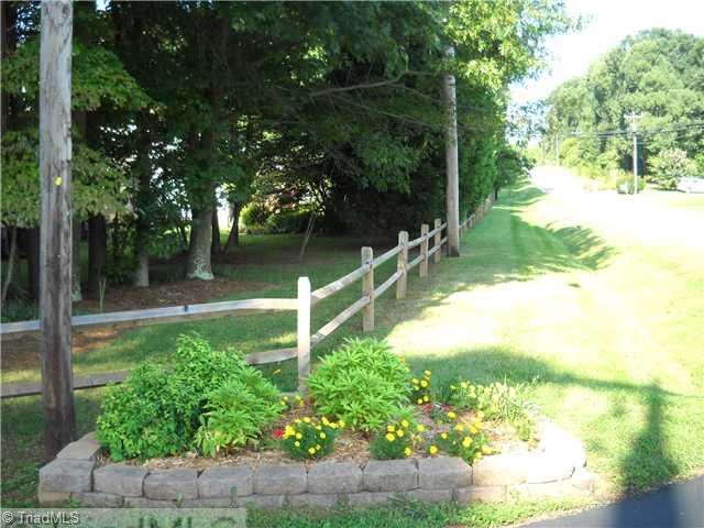 142 Old Mill Road, Unit D High Point, NC 27265 - Photo 15 of 16 Other. Nicely landscaped entrance. Mature trees along the road add to the appeal of this townhome community.Toenhomes are set well back from the road, making it a quiet neighborhood.