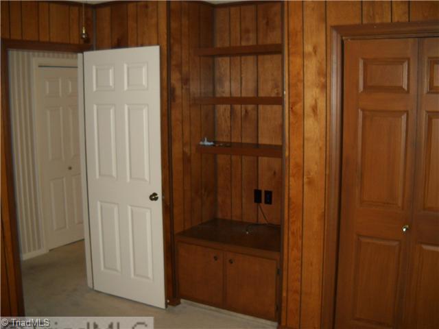 142 Old Mill Road, Unit D High Point, NC 27265 - Photo 7 of 16 3rd Bedroom. Third bedroom is currently set up as a den with built-in shelves and cabinet. Sliding doors (not in photo) open to the rear deck.