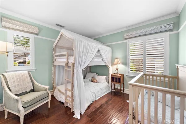 a bedroom with furniture and a wooden floor