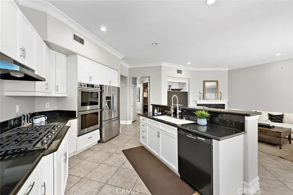 a kitchen with a stove a sink dishwasher and a refrigerator
