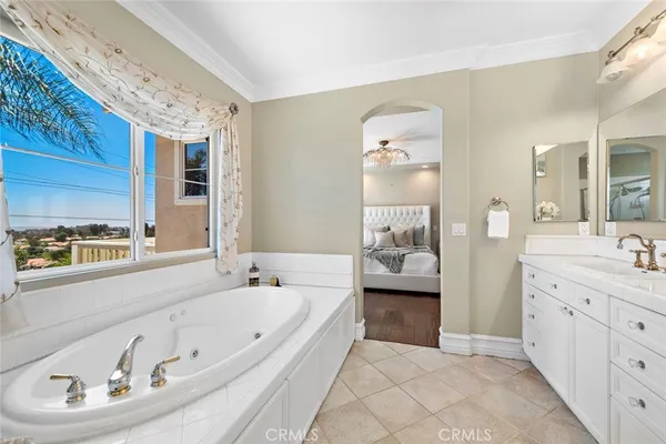 a bathroom with a tub sink and mirror