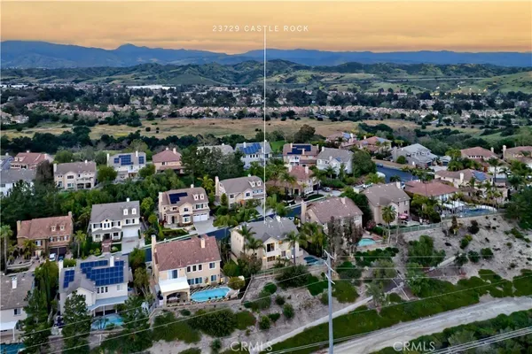 an aerial view of residential houses with city view