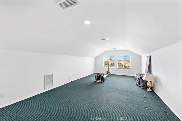 an empty room with air conditioner duct and materials on floor