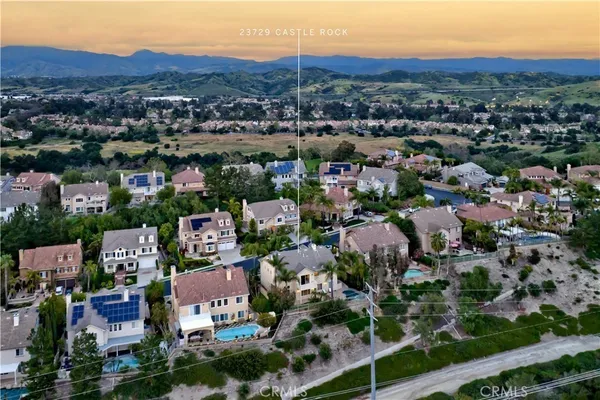 an aerial view of residential houses with city view