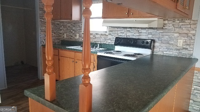 2331 Kesler Road Carnesville, GA 30521 - Photo 32 of 50 a kitchen with stainless steel appliances granite countertop a barbecue grill and a refrigerator
