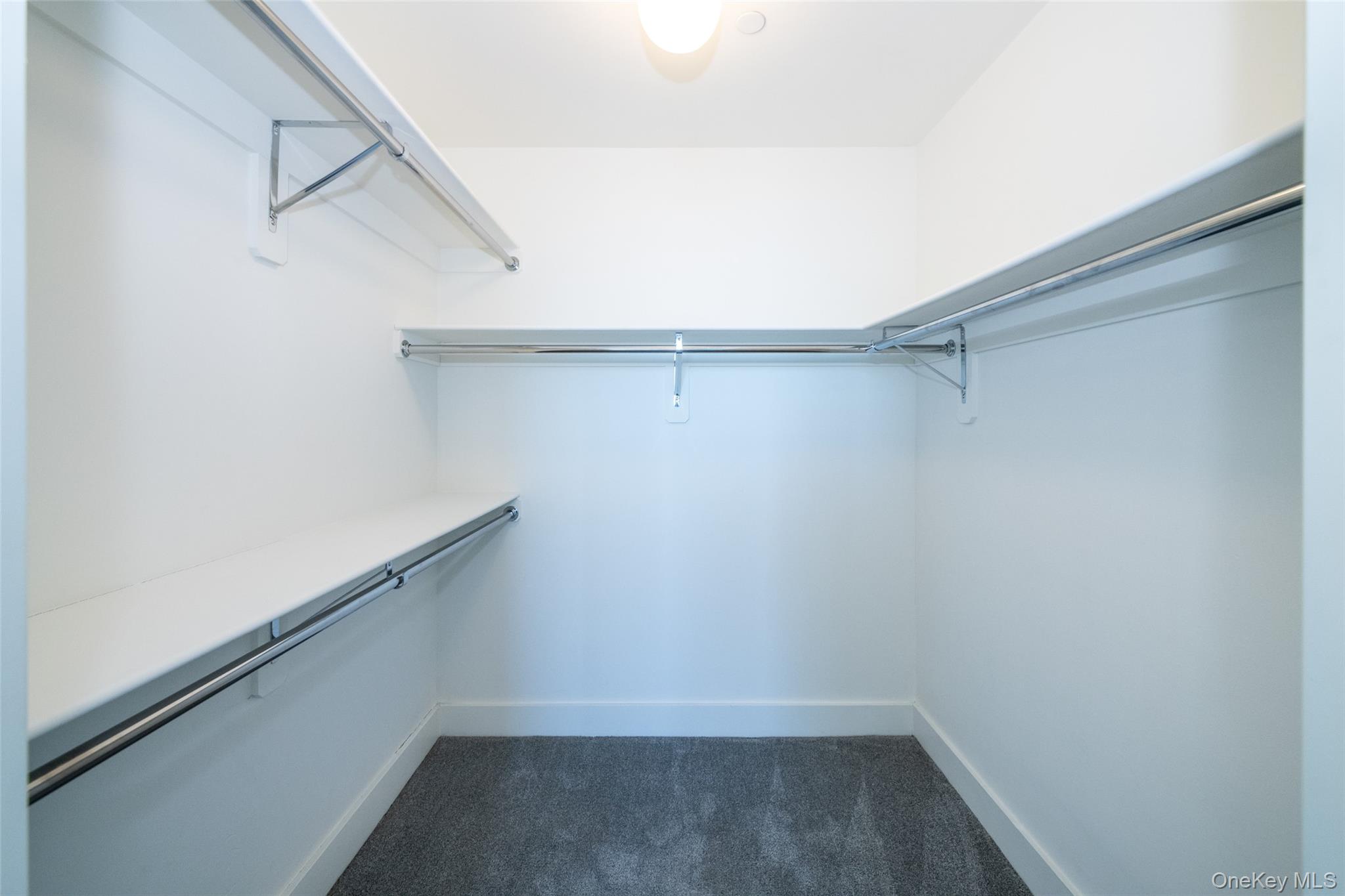 175 Huguenot Street, Unit 1402 New Rochelle, NY 10801 - Photo 15 of 24 Spacious walk in closet featuring dark carpet