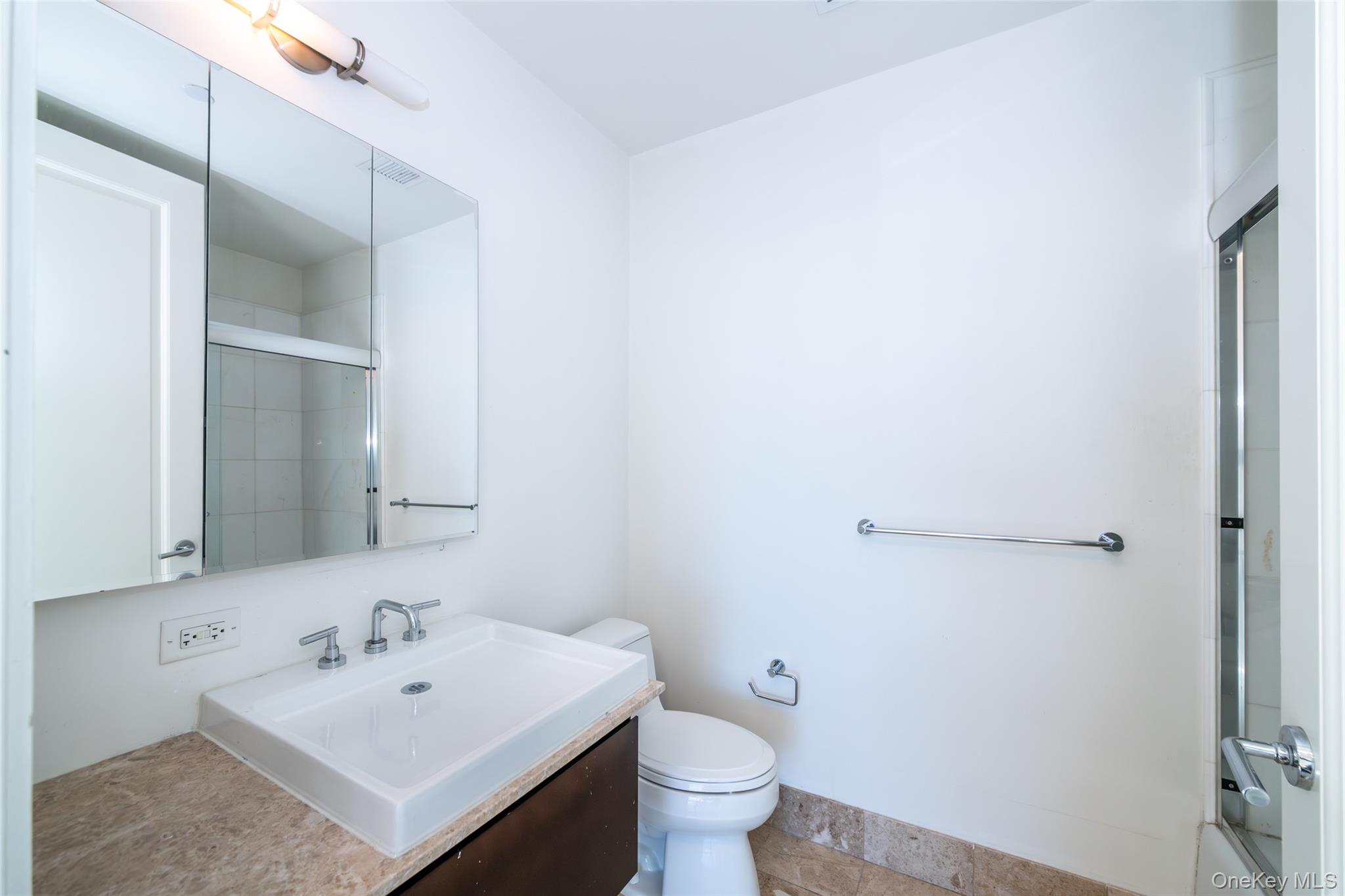 175 Huguenot Street, Unit 1402 New Rochelle, NY 10801 - Photo 19 of 24 Second bedroom full bathroom featuring vanity and shower / bath combination with glass door