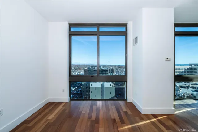 wooden floor in an empty room with a window