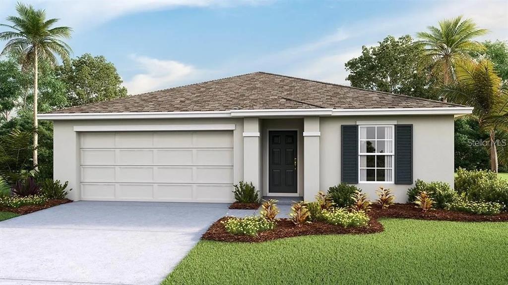 a front view of a house with a garden and yard