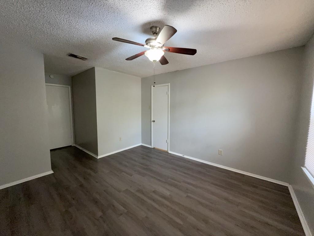 219 Fry Street, Unit 6 Denton, TX 76201 - Photo 13 of 13 a view of an empty room with wooden floor