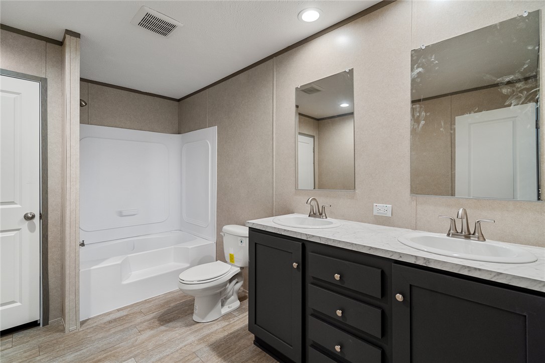 419 Austin Drive Anderson, SC 29624 - Photo 23 of 36 This modern bathroom offers a spacious layout, dual vanities, and a combination bathtub and shower.