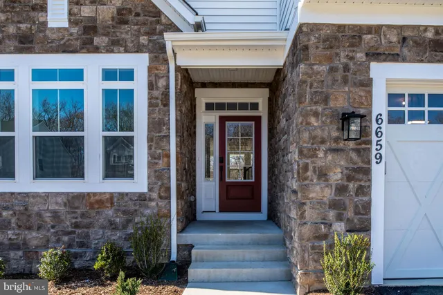 a view of entryway with wooden floor and stairs