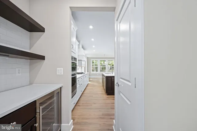 a spacious bathroom with a double vanity sink a mirror and a bathtub