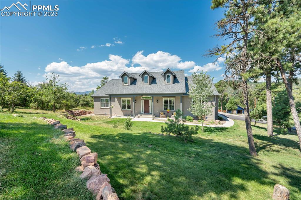 a view of a house with a yard porch and sitting area