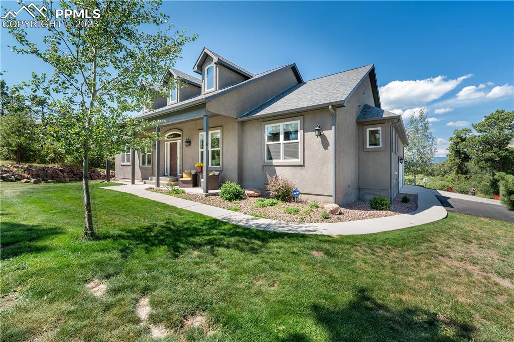 15721 South Furrow Road Larkspur, CO 80118 - Photo 15 of 50 a front view of house with a garden and patio