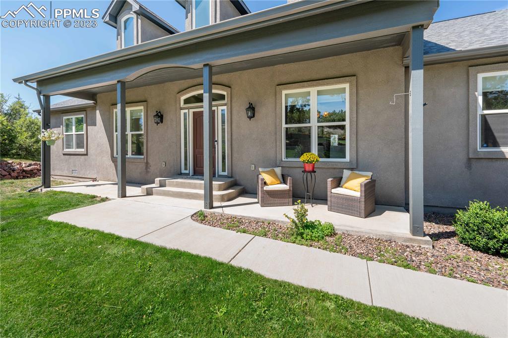 15721 South Furrow Road Larkspur, CO 80118 - Photo 16 of 50 a front view of a house with porch and sitting area