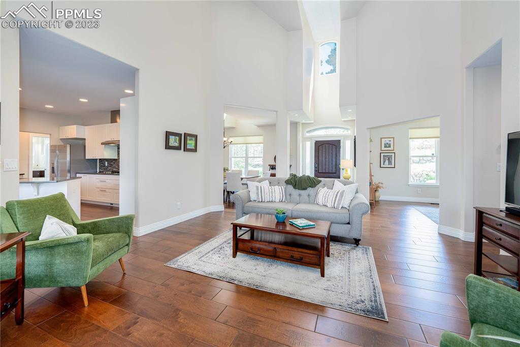 15721 South Furrow Road Larkspur, CO 80118 - Photo 17 of 50 a living room with fireplace furniture and a wooden floor