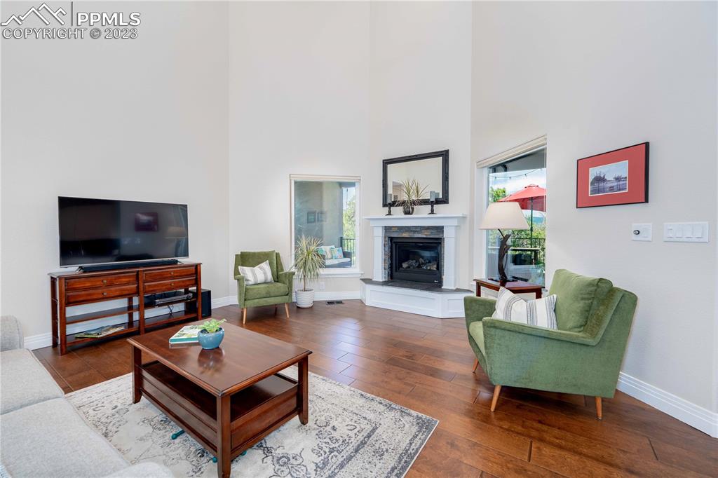 15721 South Furrow Road Larkspur, CO 80118 - Photo 19 of 50 a living room with furniture and a fireplace