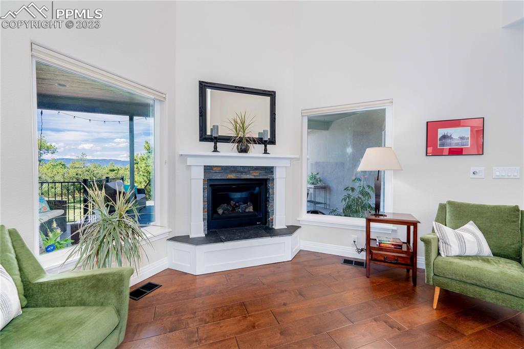 15721 South Furrow Road Larkspur, CO 80118 - Photo 20 of 50 a living room with furniture and a fireplace