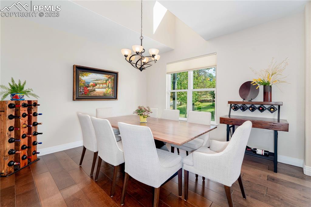 15721 South Furrow Road Larkspur, CO 80118 - Photo 21 of 50 a view of a dining room with furniture window and wooden floor