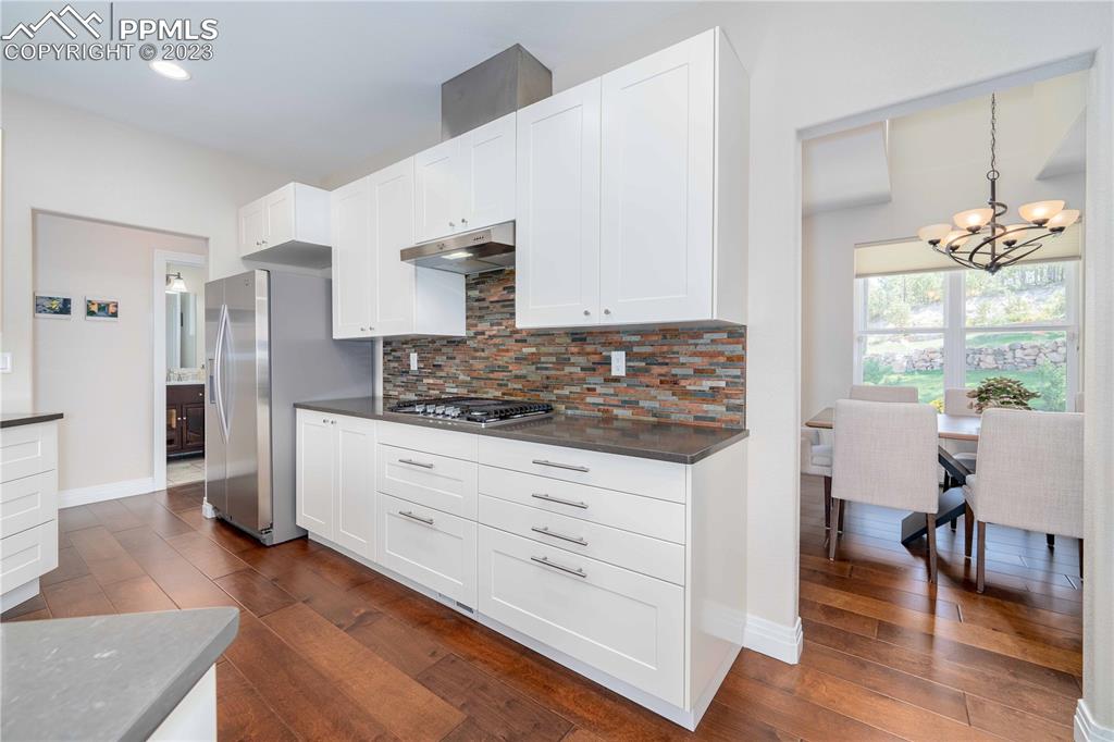 15721 South Furrow Road Larkspur, CO 80118 - Photo 24 of 50 a kitchen with stainless steel appliances granite countertop a stove and a refrigerator