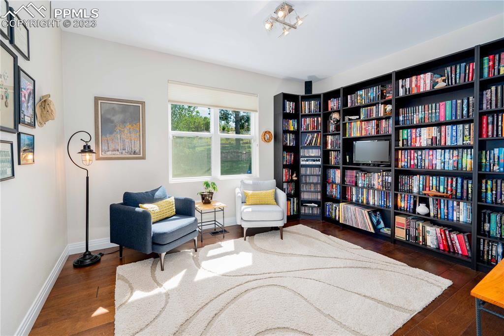 15721 South Furrow Road Larkspur, CO 80118 - Photo 27 of 50 a living room with furniture and a book shelf