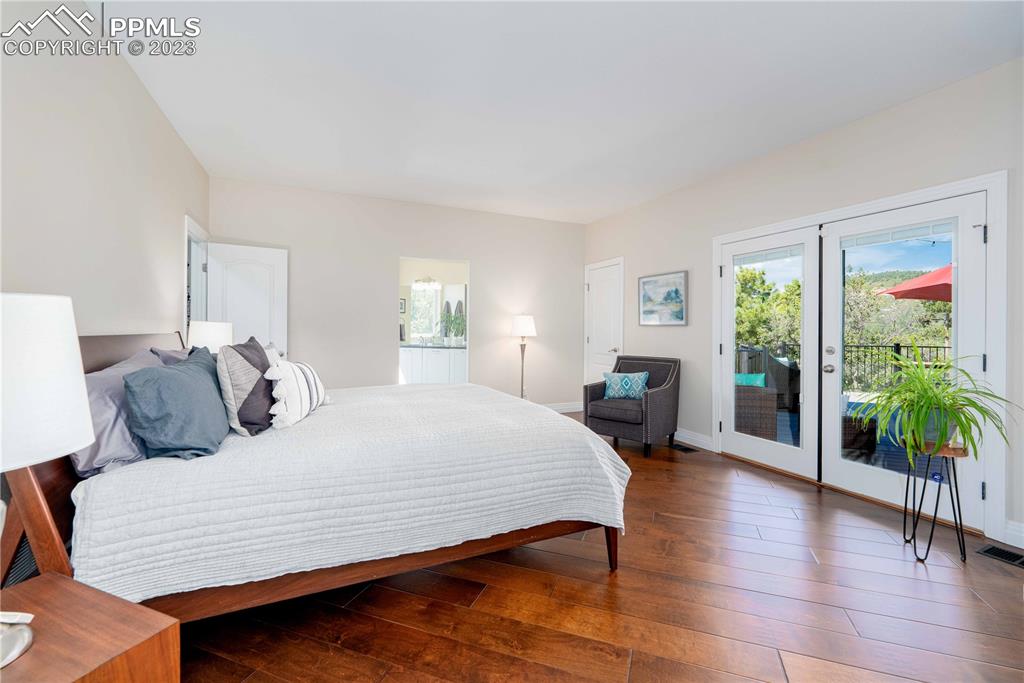 15721 South Furrow Road Larkspur, CO 80118 - Photo 29 of 50 a large bedroom with a bed and a table