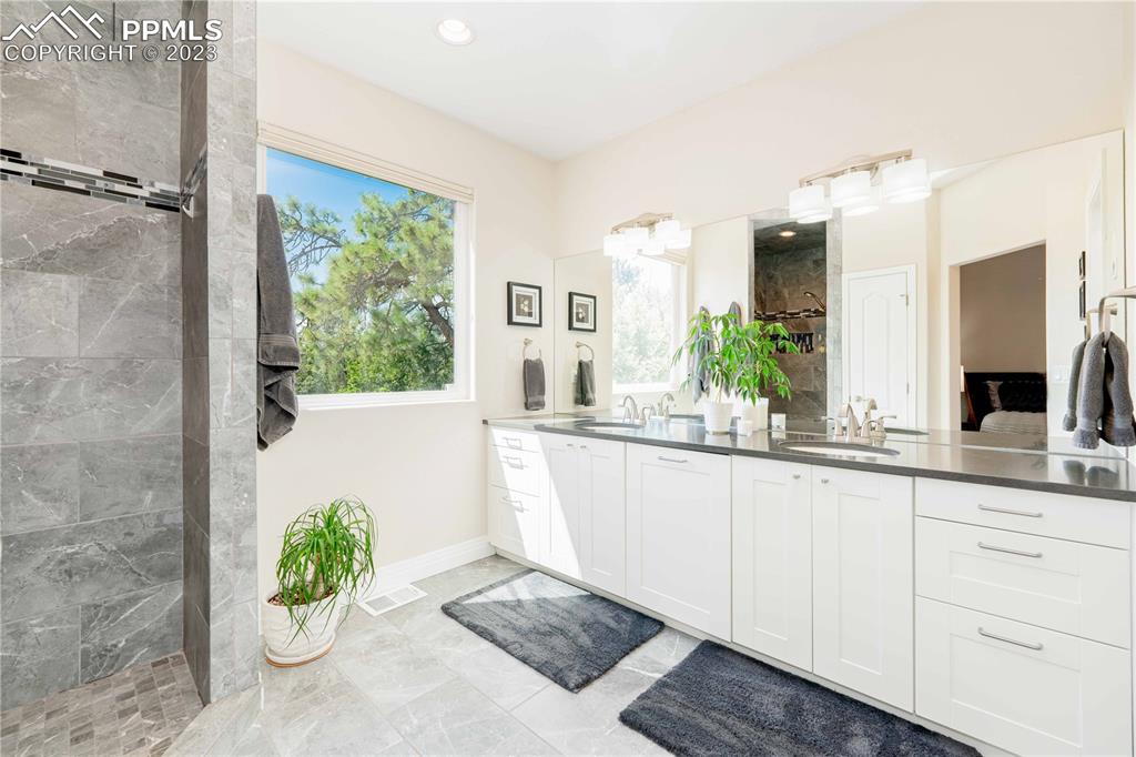 15721 South Furrow Road Larkspur, CO 80118 - Photo 31 of 50 a white bath tub sitting in a bathroom next to a window