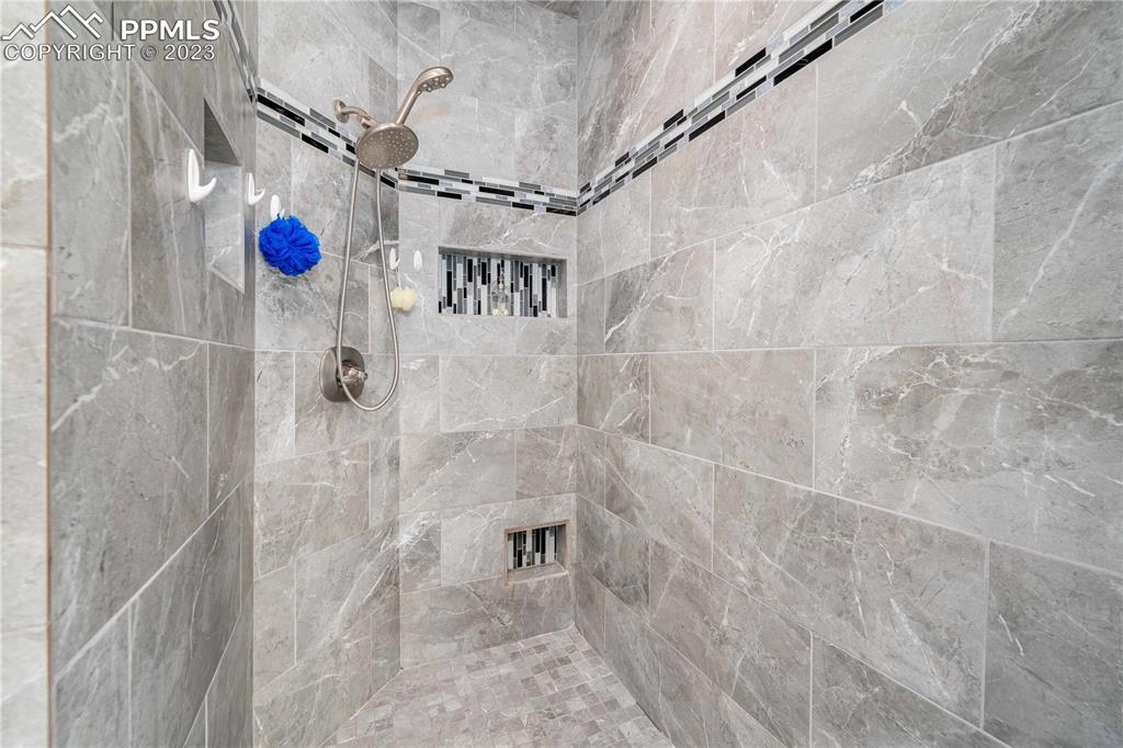 15721 South Furrow Road Larkspur, CO 80118 - Photo 32 of 50 a bathroom with a shower