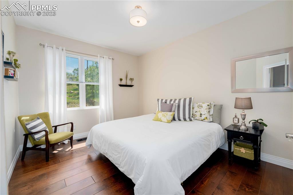 15721 South Furrow Road Larkspur, CO 80118 - Photo 33 of 50 a bedroom with a bed and a window