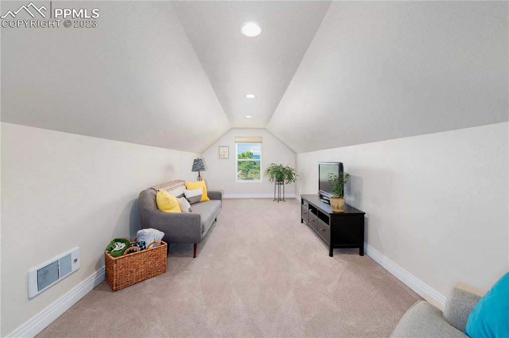 15721 South Furrow Road Larkspur, CO 80118 - Photo 34 of 50 a living room with furniture and a large window
